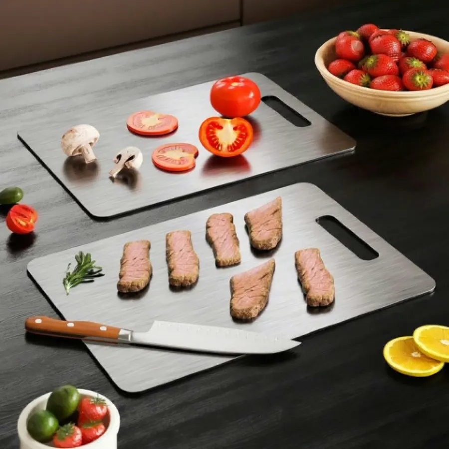 Two Katori titanium cutting boards with steak slices and tomatoes